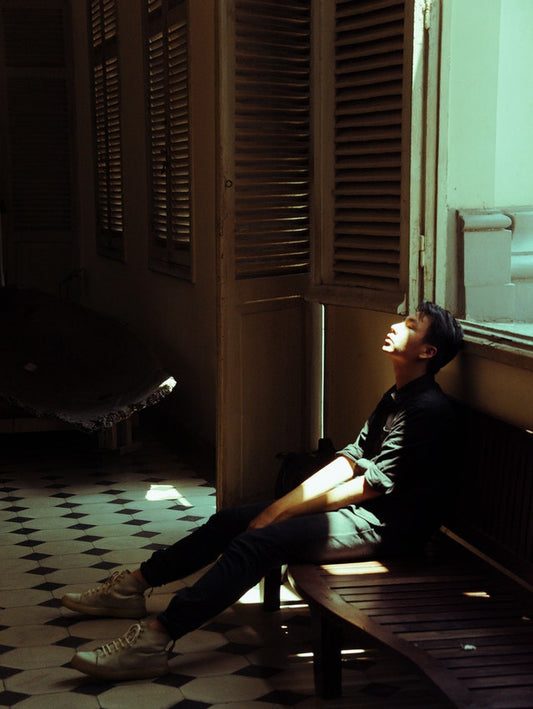 An image of person sitting on a bench