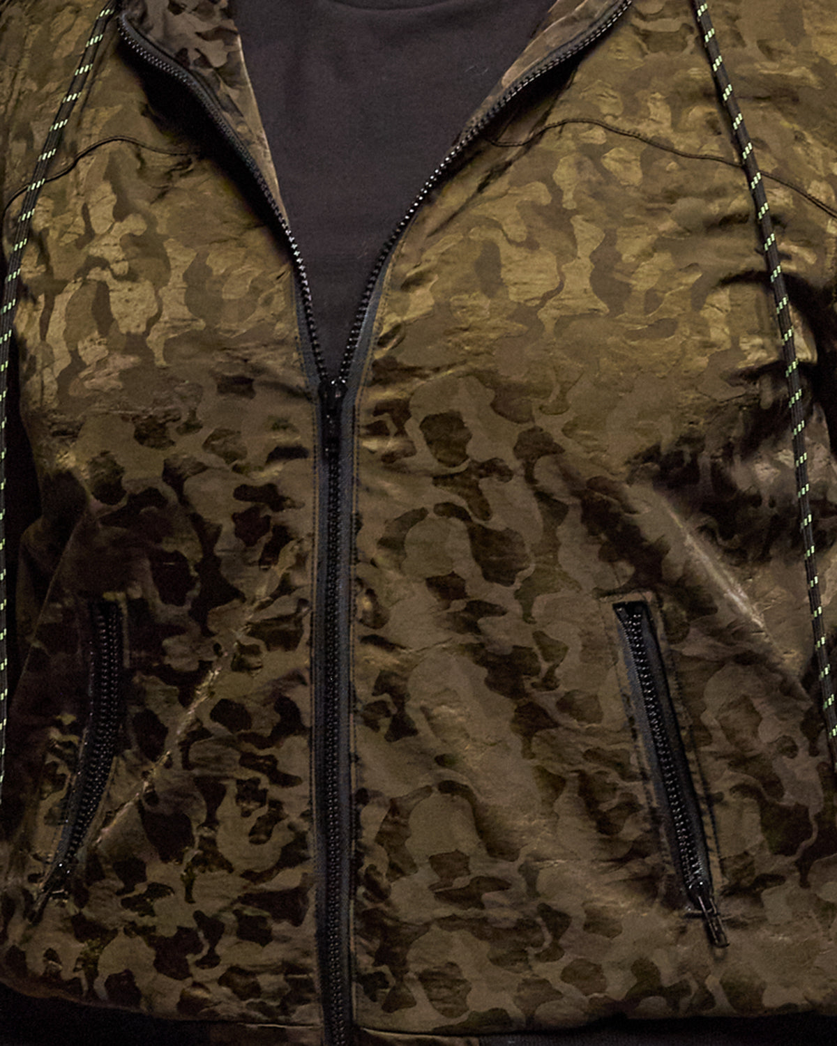 Close-up of the brocade fabric, zipper and pockets on the Jay Victoria bomber jacket.