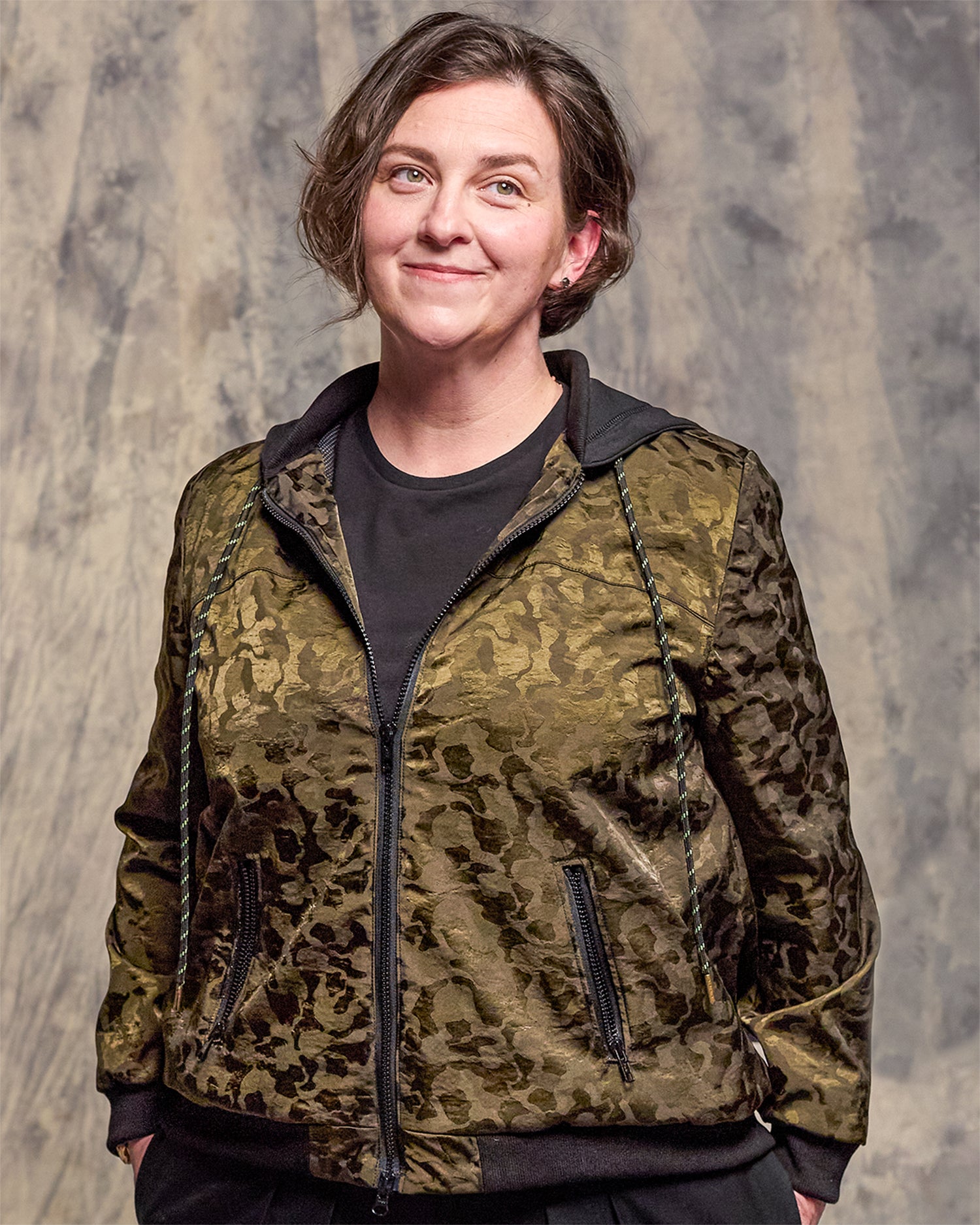 Model wearing the Jay Victoria menswear-inspired bomber jacket in olive brocade.